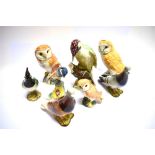 A GROUP OF TEN BESWICK BIRDS comprising Chickadee model 929, two barn owls 19cm high and another