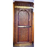 A LARGE POLYCHROME DECORATED AND CARVED MOORISH DOOR 58cm wide 210cm high
