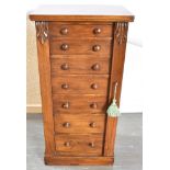 A VICTORIAN MAHOGANY WELLINGTON CHEST fitted with seven graduated drawers, with carved corbels on