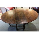 AN OAK GATELEG TABLE the oval top 80cm deep 132cm wide including both leaves, drawer to one end,