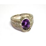 A PURPLE SAPPHIRE AND DIAMOND MODERN 18CT GOLD WHITE GOLD BARREL RING With diamond set shoulder,