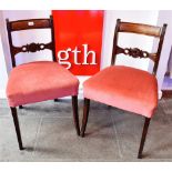 A PAIR OF REGENCY SABRE LEG DINING CHAIRS with carved bar backs