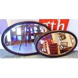 TWO OVAL WALL MIRRORS 82cm and 75cm wide