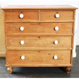 A PINE CHEST OF TWO SHORT AND THREE LONG DRAWERS with ceramic handles on bun feet, 117cm wide 54cm