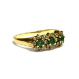 AN EMERALD AND DIAMOND TRIPLE CLUSTER 9CT GOLD RING comprising three small round cut emeralds with