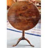 A PROVINCIAL OAK TRIPOD OCCASIONAL TABLE the circular tilt top 55cm diameter, 69cm high