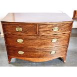 A MAHOGANY BOW FRONT CHEST OF TWO SHORT AND TWO LONG DRAWERS on splayed bracket feet, 105cm wide