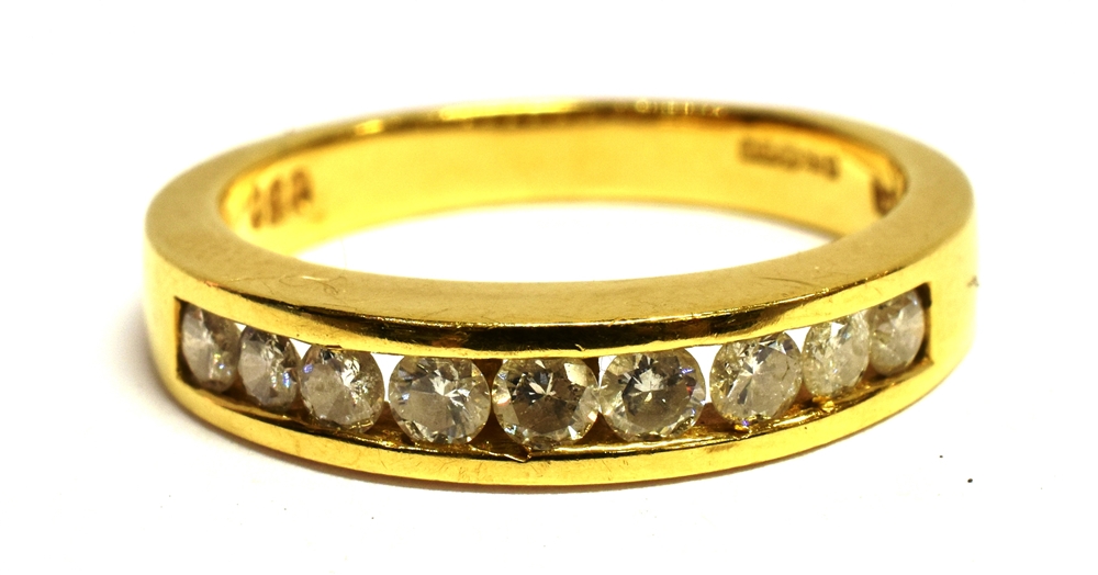 A DIAMOND HALF ETERNITY 18CT YELLOW GOLD RING the channel set front containing nine brilliant cut