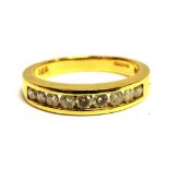 A DIAMOND HALF ETERNITY 18CT YELLOW GOLD RING the channel set front containing nine brilliant cut
