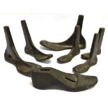 SIX CAST METAL COBBLER'S LASTS of various sizes, together with a work post with a universal