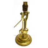A GIMBALLED BRASS TABLE LAMP with weighted base, suitable for wall mounting or as a table lamp,