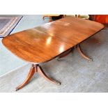 A MAHOGANY REGENCY STYLE TWIN PILLAR DINING TABLE 182cm long including additional leaf (the leaf