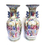A LARGE PAIR OF CANTON VASES reserves decorated with warriors on horseback, 60cm high
