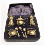 A BOXED SILVER FIVE PIECE CONDIMENT SET comprising two salts, two pepperettes and mustard,