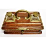 AN EDWARDIAN EP MOUNTED OAK DESK STAND with pair of glass inkwells, 27cm wide