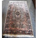 A HAND WOVEN PERSIAN RUG 89cm x 161cm