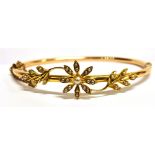 AN EDWARDIAN SEED PEARL SET YELLOW GOLD BANGLE the hinged tubular form bangle within seed pearl set,