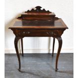 AN EDWARDIAN LADIES WRITING DESK with gilt tooled leather writing surface, frieze drawer on cabriole
