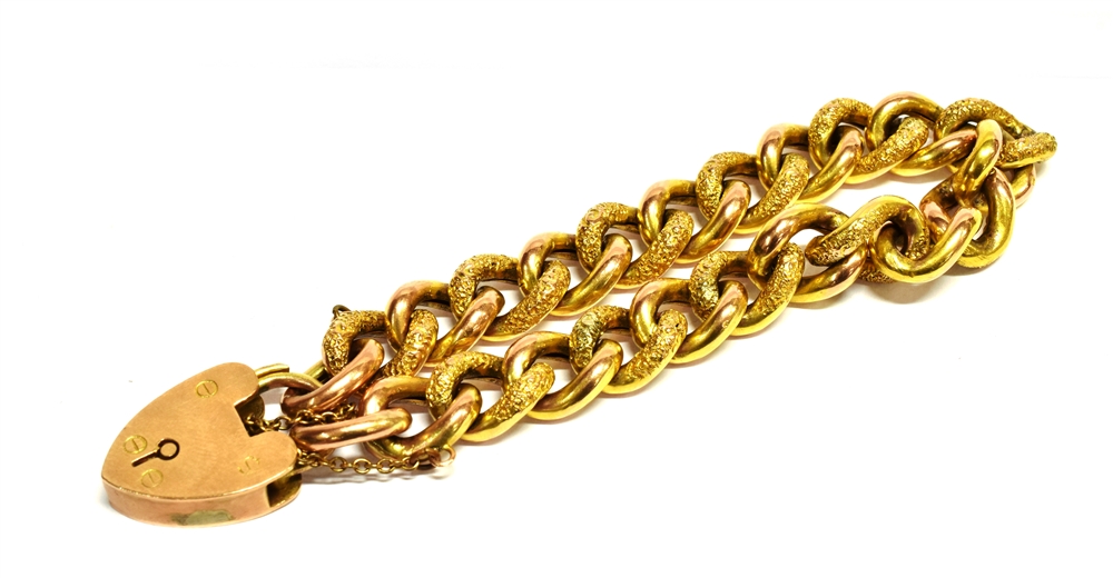 AN EARLY 20TH CENTURY 9CT GOLD CURB LINK BRACELET With padlock fastener, the hollow patented curb