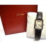 A LADIES CARTIER TANK STAINLESS STEEL WATCH On a leather strap, ivory coloured oblong dial, black