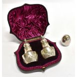 A BOXED PAIR OF VICTORIAN SILVER EGG FORM PEPPERETTES by Mappin and Webb, on three bun feet,