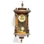 A WALNUT CASED CONTINENTAL WALL CLOCK 84cm high overall