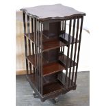 AN EDWARDIAN MAHOGANY REVOLVING BOOKCASE 51cm square, 106cm high