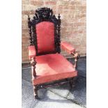 A HIGHLY CARVED VICTORIAN OAK ARMCHAIR with upholstered seat, back and armrests