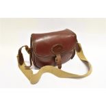 A LEATHER CARTRIDGE BAG with webbing shoulder strap, 30cm wide