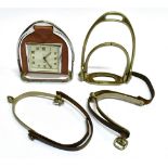 A STIRRUP for disabled use; a pair of lady's spurs and a Smiths mantle clock in leather mount hung