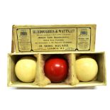 THREE EARLY 20TH CENTIRY IVORY BILLIARD BALLS two natural white, one stained red, in original