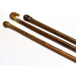 A WALKING CANE with bird head grip and plated collar and two others (3)