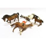 A BESWICK FIGURE OF A BAY HORSE 15cm high; a bay foal, 12cm high; a Huntsman on a bay horse, 22cm (