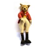 A SOFT TOY STANDING FOX FIGURE in hunting dress, with retailers label 'F.E.Gibson, Newmarket' height