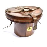 A LEATHER OVAL TOP HAT BOX with red velvet lined interior, 24cm high, 36cm wide