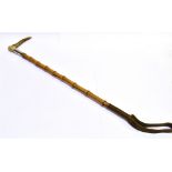 A RIDING CROP, with antler grip, silver collar and ribbed bamboo shaft
