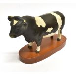 A BESWICK FIGURE OF A FRIESIAN BULL 'Champion Coddington Hilt Bar' on a wooden plinth, 14.5cm