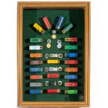 A CARTRIDGE DISPLAY comprising an arrangement of twenty-six assorted cartridges mounted on green