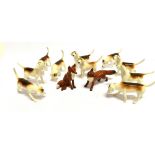 TEN BESWICK FIGURES OF HOUNDS and two fox figures, one seated, 7.5cm high