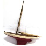 A TOY POND YACHT the wooden hull with a plank-effect deck and a weighted keel, complete with mast