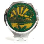 AUTOMOBILIA - A YOUNG FARMERS CLUB CHROME BUMPER BADGE with a green and yellow plastic ploughing
