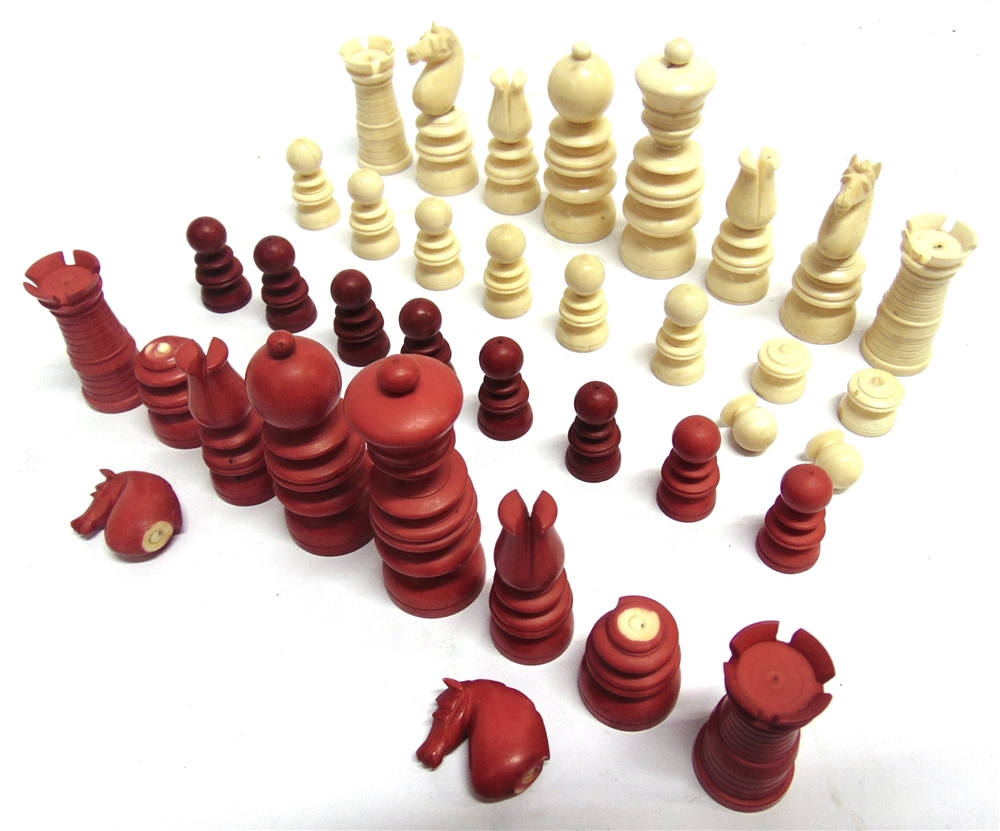 A LATE 19TH CENTURY CARVED IVORY CHESS SET natural white and stained red, the kings 8.25cm high (red