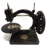 A WANZER SEWING MACHINE CO. 'TIME UTILIZER' SEWING MACHINE serial number 556311, the black japanned,