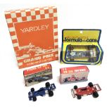 FOUR DIECAST MODEL FORMULA 1 RACING CARS including a Yardley Gift Set, each mint or near mint and