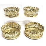 A VICTORIAN SET OF FOUR LARGE BOTTLE COASTERS The round coasters with pierced open work gallery