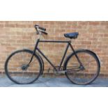 A RALEIGH GENTLEMAN'S BICYCLE black, with a front cable brake, (for restoration).