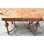 A CONTINENTAL OAK DINING TABLE the rectangular top with canted corners, carved with masks to