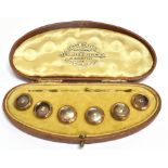 AN EDWARDIAN BOXED SET OF SIX YELLOW METAL WHITE STONE SET GENTS DRESS STUDS Together with a boxed