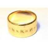 A HALLMARKED 9CT YELLOW GOLD WEDDING BAND 10mm wide, star cut design, chamfered edge, size O,