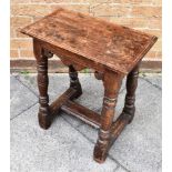 AN OAK JOINT STOOL the rectangular top with moulded edge, 48cm x 17cm, frieze with carved apron,